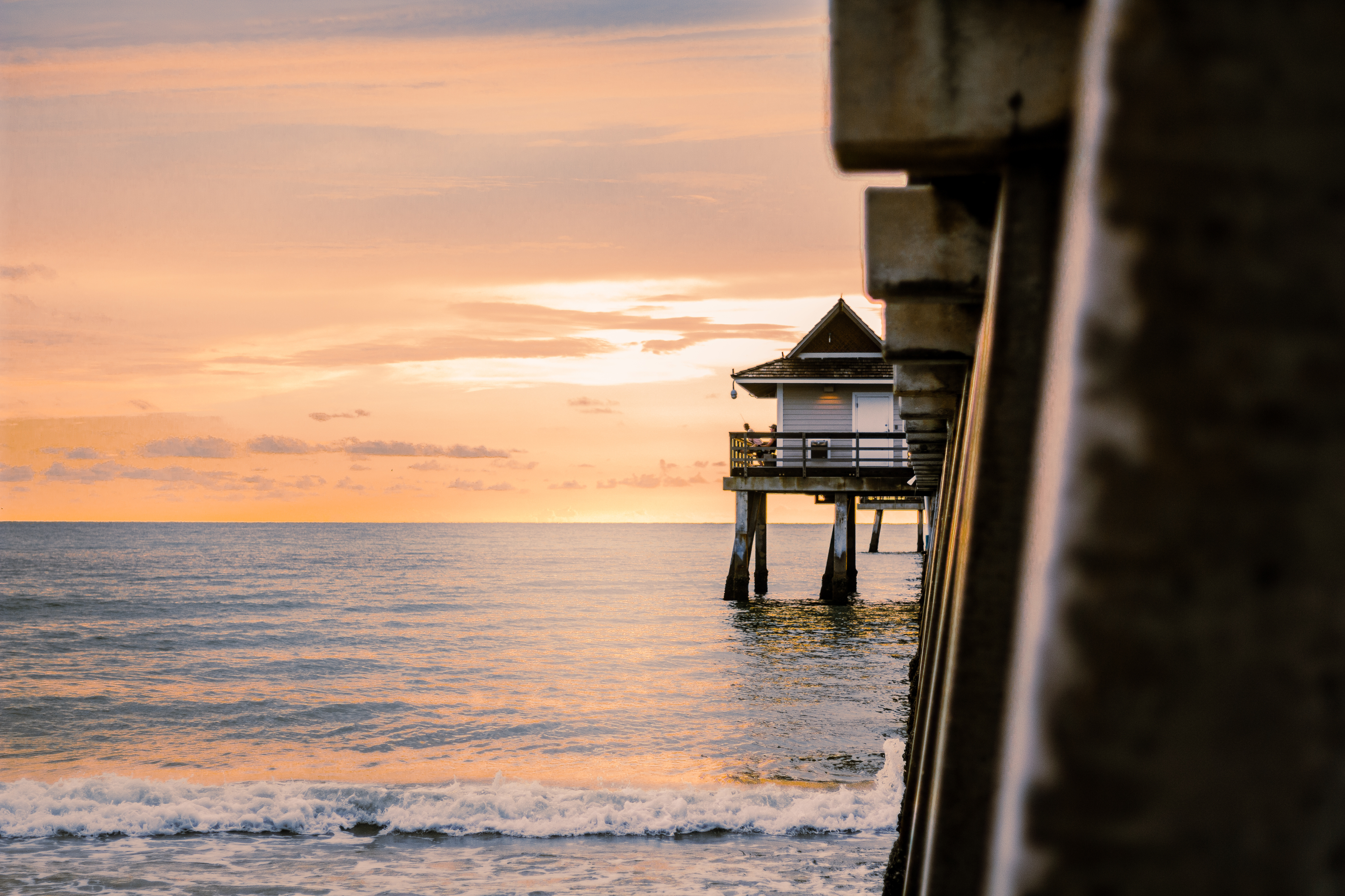 naples florida pier side view ocean waves sunset clouds naples florida pier side view ocean waves sunset clouds