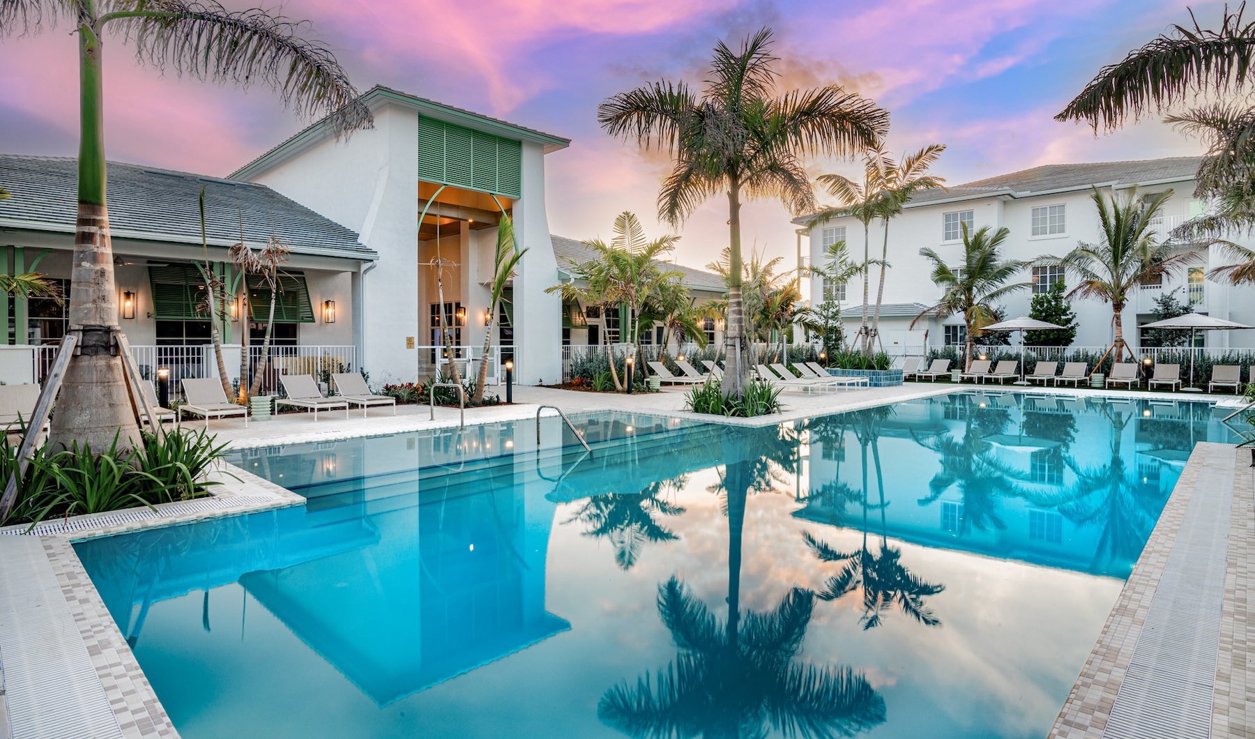 a courtyard with a pool and palm trees