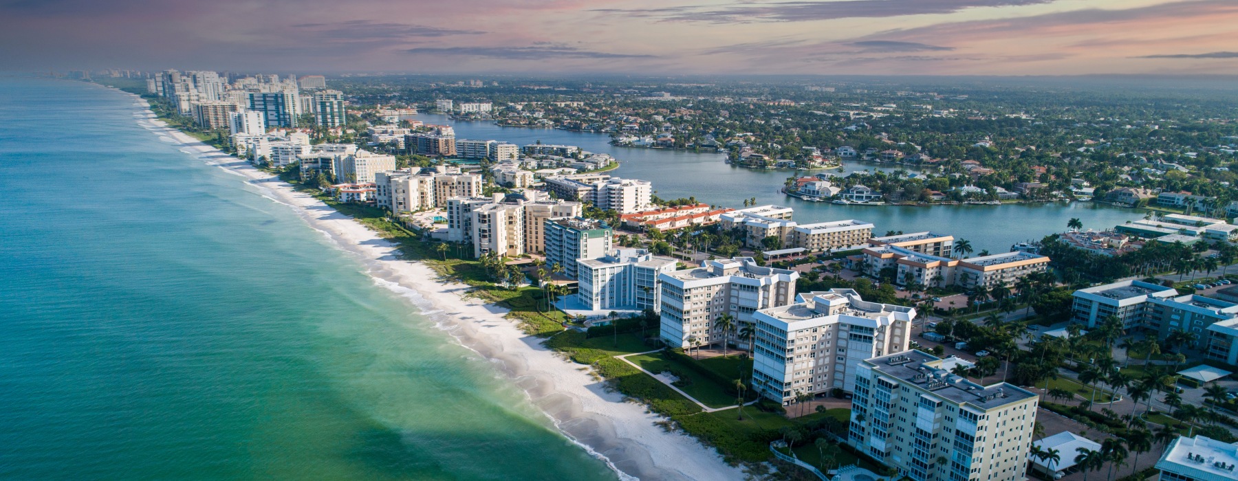 naples florida coastline beach water highrises sunset sky