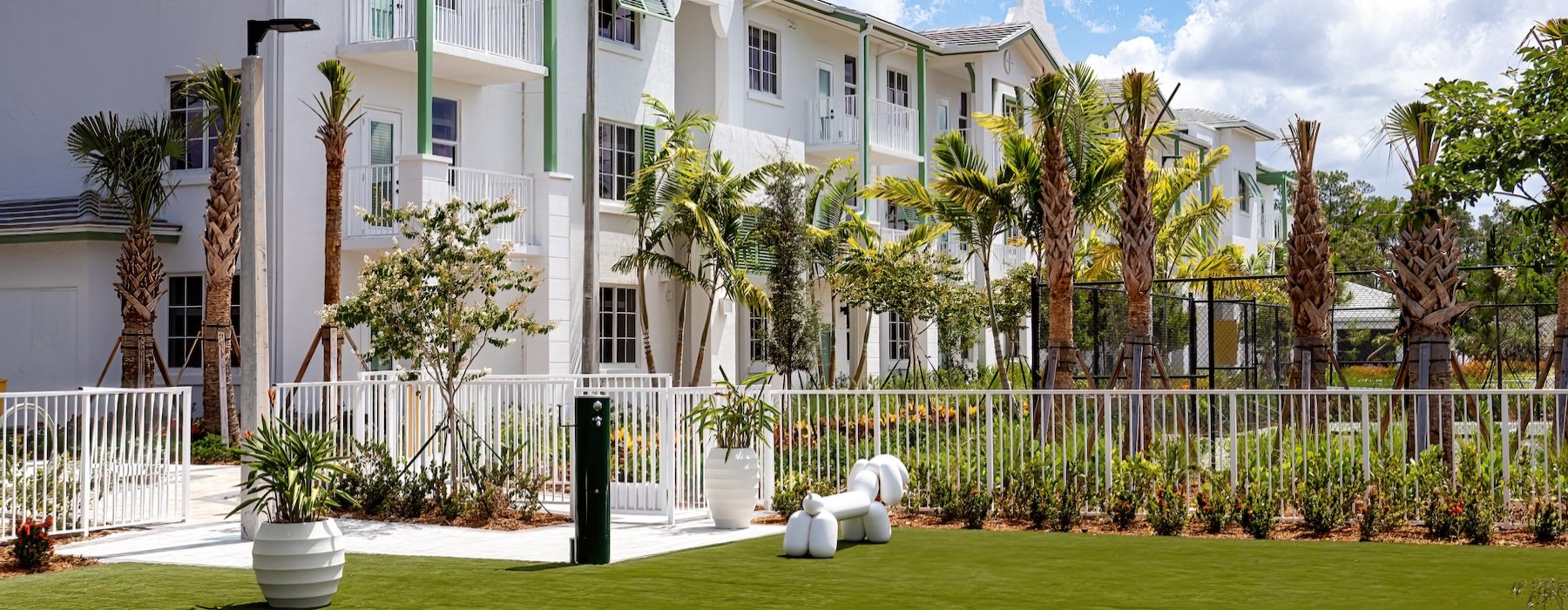 a white house with palm trees