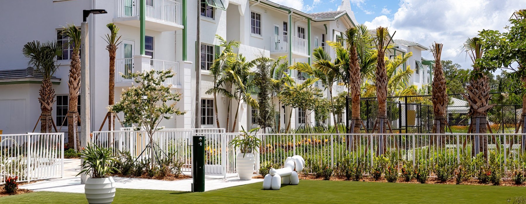 a white house with palm trees