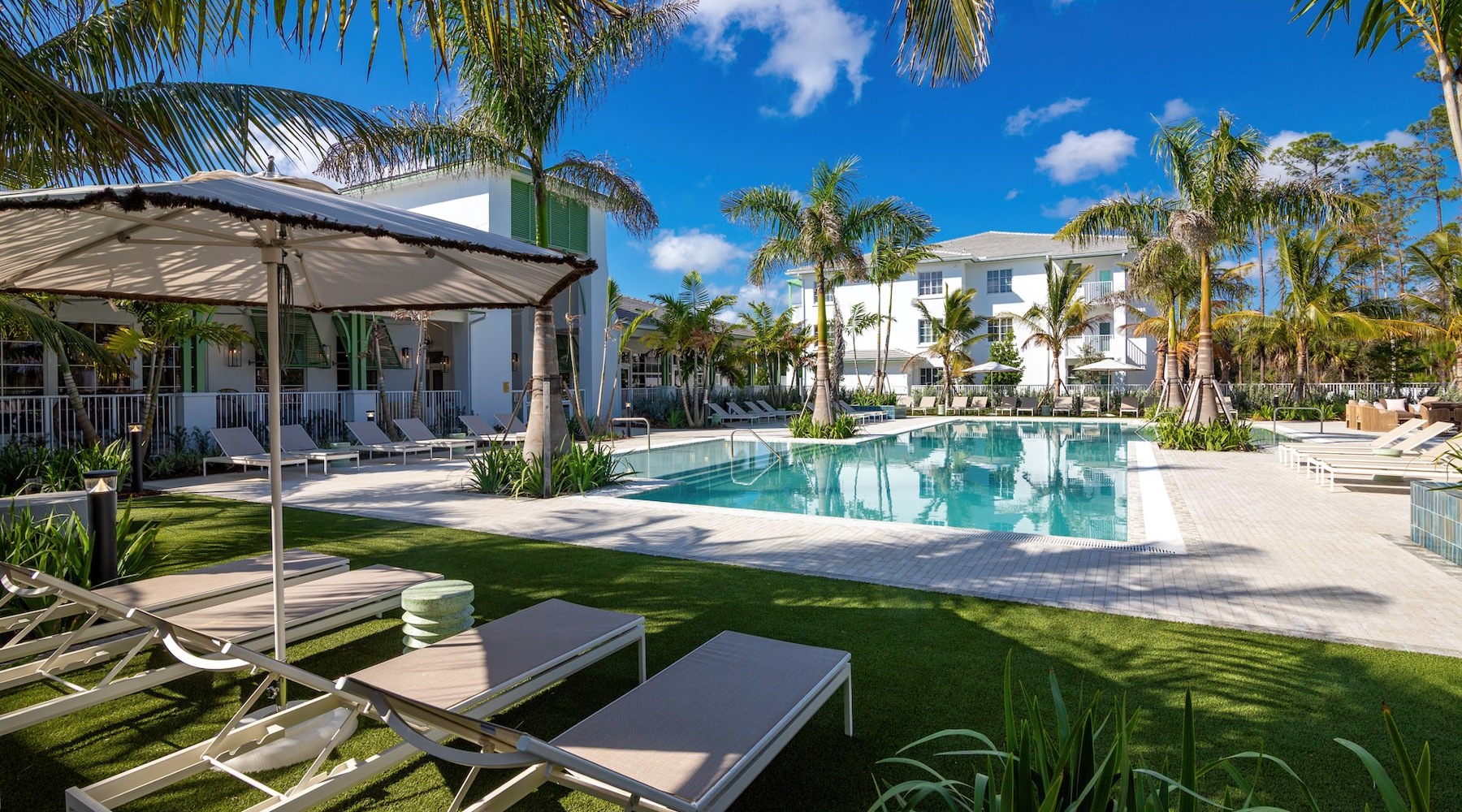 a courtyard with a pool and chairs